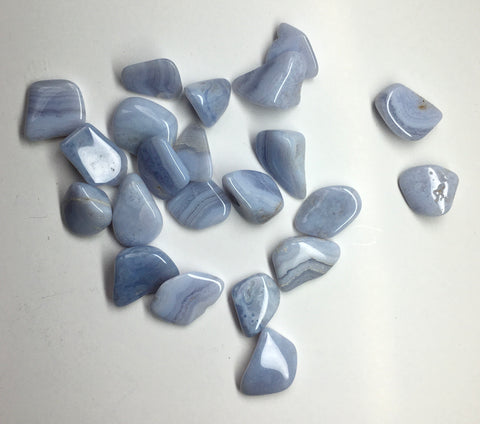 Tumbled stone blue lace agate. This small and smooth gemstone has bands of blue and white
